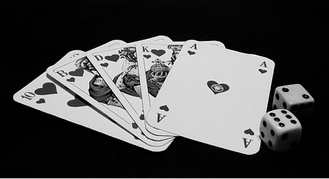 Playing cards and dice rendered in b&w